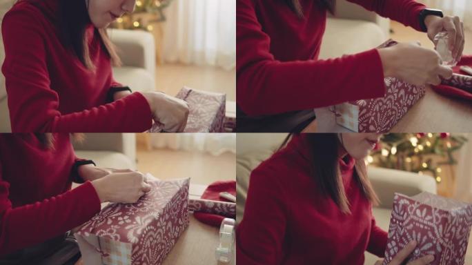 新型冠状病毒肺炎期间在家准备圣诞礼物的年轻女子包装礼品盒。