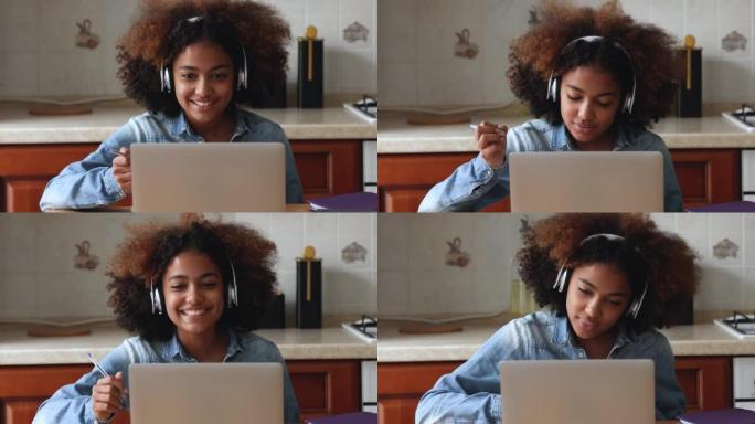 耳机中的黑人女士在笔记本电脑上的会议应用程序中学习