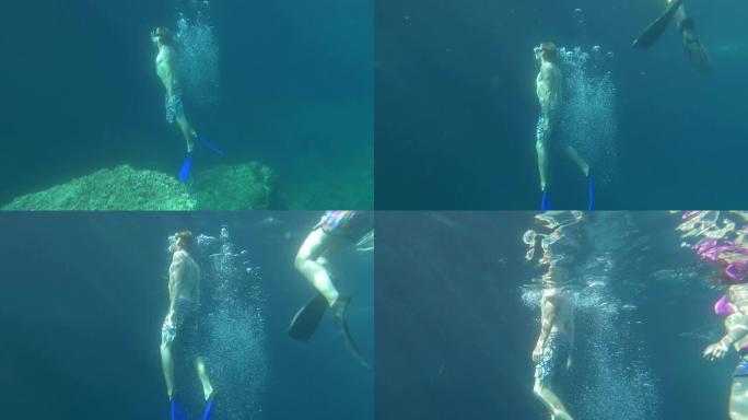 水下: 两名潜水员升至海平面