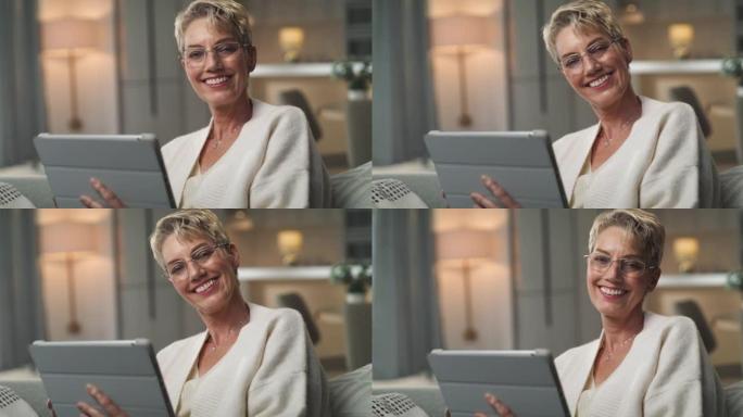 一名高级女性坐在家里使用数字平板电脑的4k视频片段