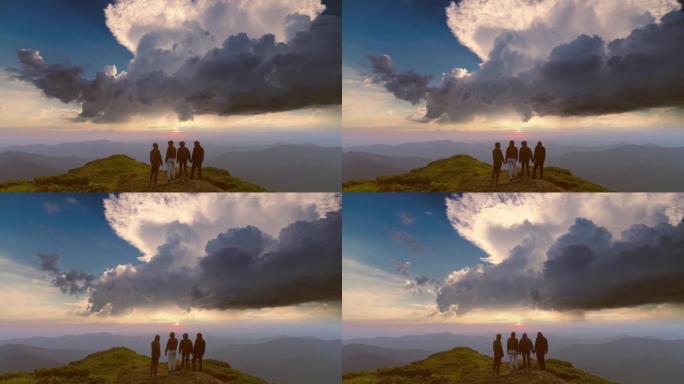 四位朋友在夕阳下站在山上