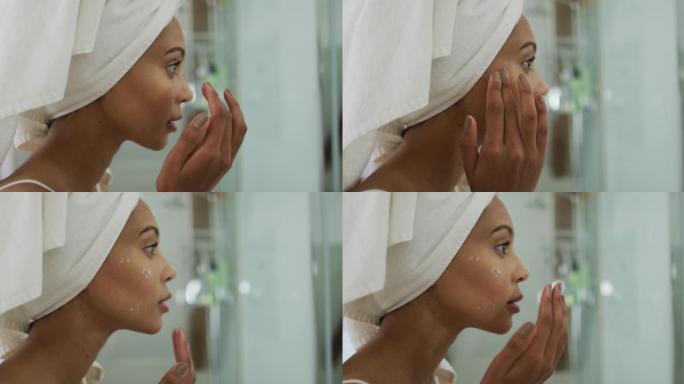 混血女人头上戴着毛巾在脸上涂上奶油