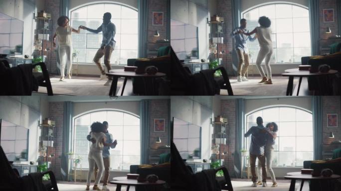 快乐的黑人夫妇在客厅跳舞。开朗的女友和男朋友享受真爱，好心情和充满活力的音乐在家里玩得开心。时尚的内