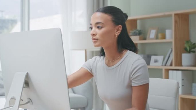 4k视频片段，一名年轻女子独自一人坐在家里使用计算机工作