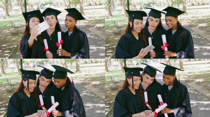 一群毕业生在大学校园毕业典礼后使用手机进行社交媒体自拍照。大学毕业后使用技术和持有学位的女性和朋友