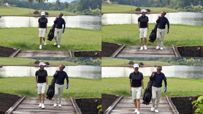 一名亚洲华裔男子带着他的十几岁的儿子走向高尔夫球场，带着高尔夫球袋看着风景