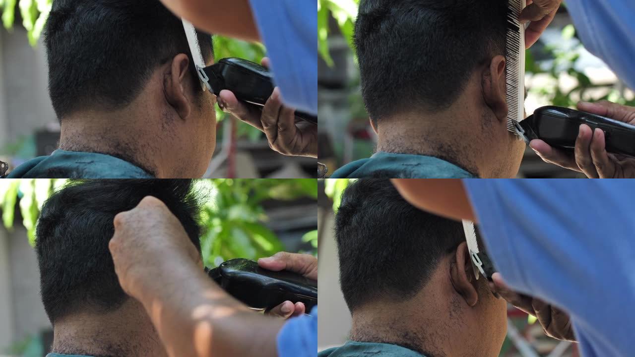 理发师的特写镜头用理发推子剪头发。