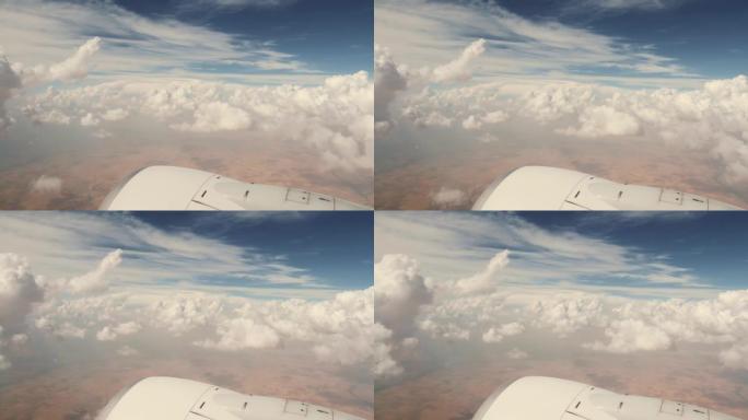 飞行旅行期间从飞机窗口看到美丽的天空，令人惊叹的大云空中全景和飞机引擎。