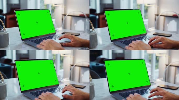 笔记本电脑上的绿屏模拟显示。使用触摸板，滚动内容，在现代家庭中近距离工作。智能手机位于计算机旁边。