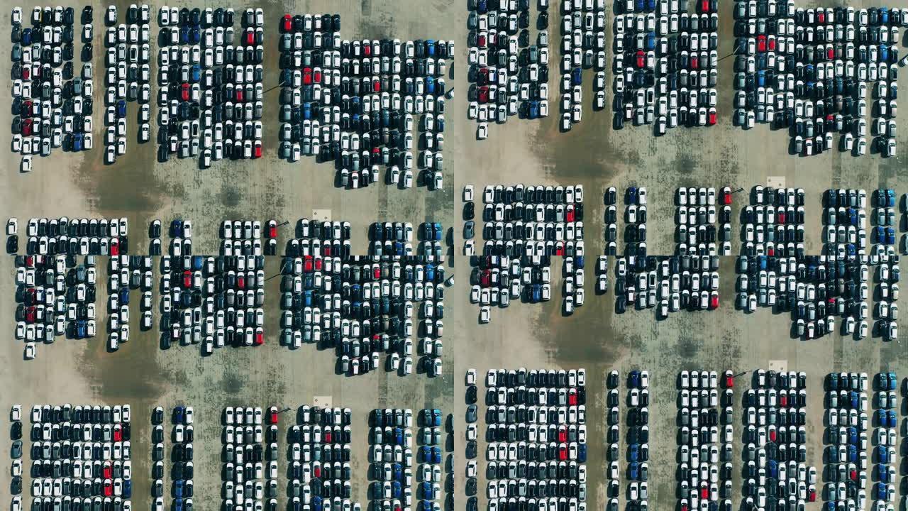多辆新制造的汽车在停车场的俯视图。