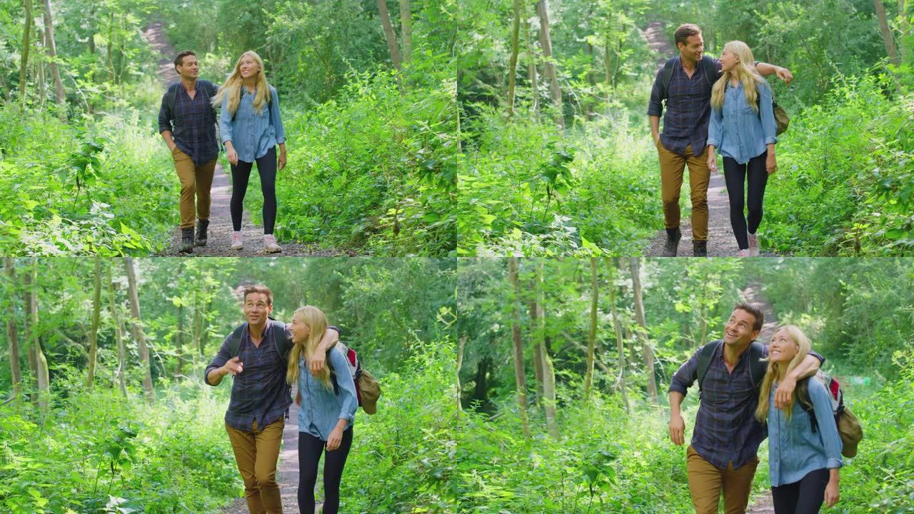 乡下的情侣一起沿着森林徒步旅行