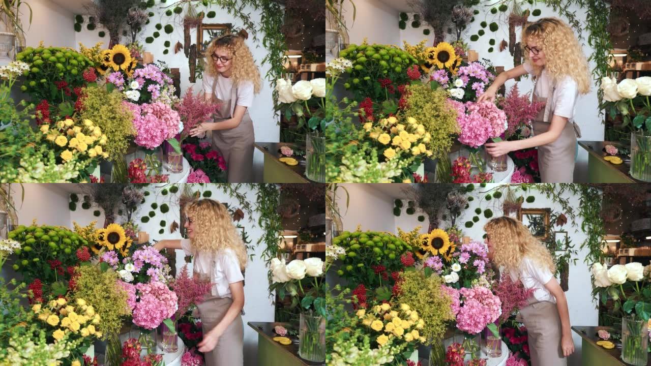 女花店享受她的花的美丽。