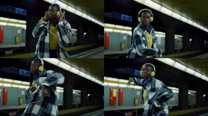 年轻时尚的黑人妇女，戴着黄色耳机，在空荡荡的地铁站独自听音乐和跳舞。充满活力的自信年轻女性跟随节拍并
