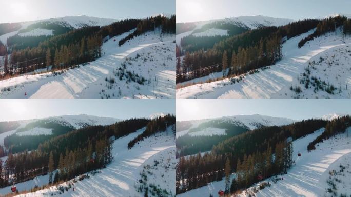 冬季娱乐无人机飞过滑雪缆车，在阳光明媚的雪山背景下，在美丽的斜坡小径上工作。