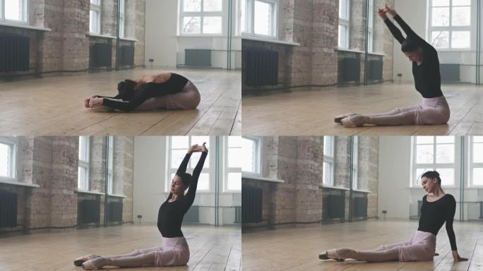优雅的芭蕾舞演员在地板上做伸展运动