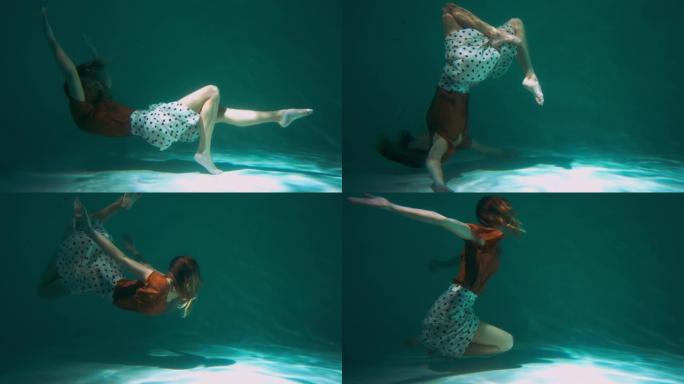 大气拍摄的年轻美丽优雅的舞者女人做现代舞动作在水下慢动作下向后翻转。