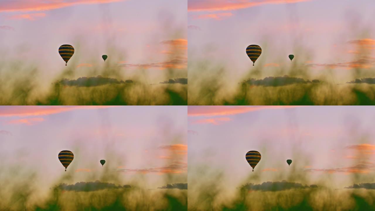 热气球在乡村田野上宁静的天空中飞行