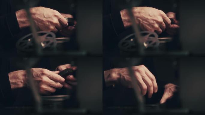 一个男人的手的特写镜头使用剪辑表进行8毫米电影的视频剪辑。
