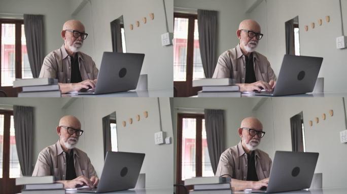 日本高级男子在客厅使用笔记本电脑