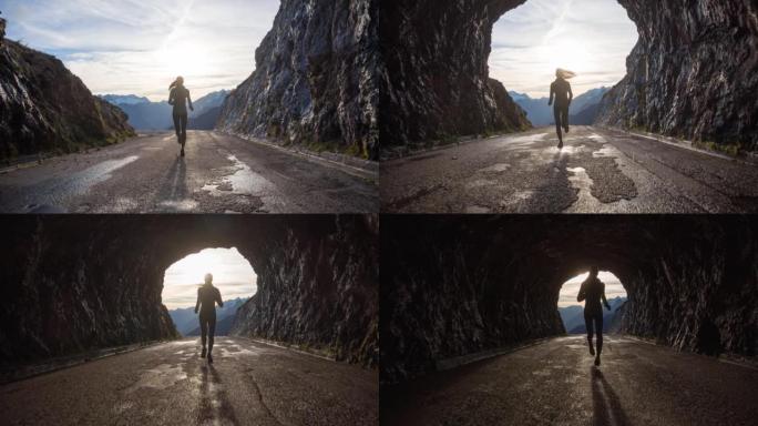 年轻的女运动员在山上高高的隧道中奔跑