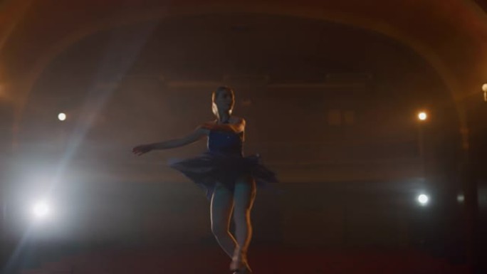 SLO MO Young芭蕾舞演员在空荡荡的剧院舞台上旋转