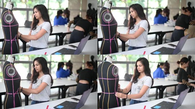 亚洲大学时装学生在教室里上课，与人体模特一起从事时装设计项目
