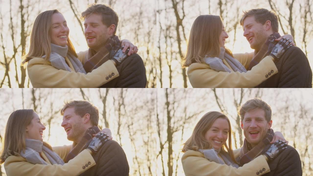 冬季或秋季乡村与假手拥抱的浪漫夫妇的肖像-慢动作拍摄