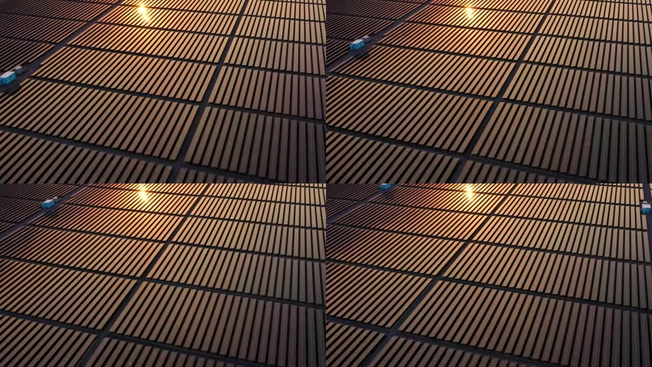日落时太阳能电池板的空中无人机视图