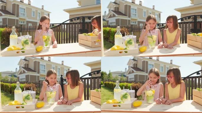 10岁的姐妹在户外做柠檬水