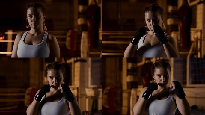慢动作严肃的女拳击手在镜头前摆出格斗姿势