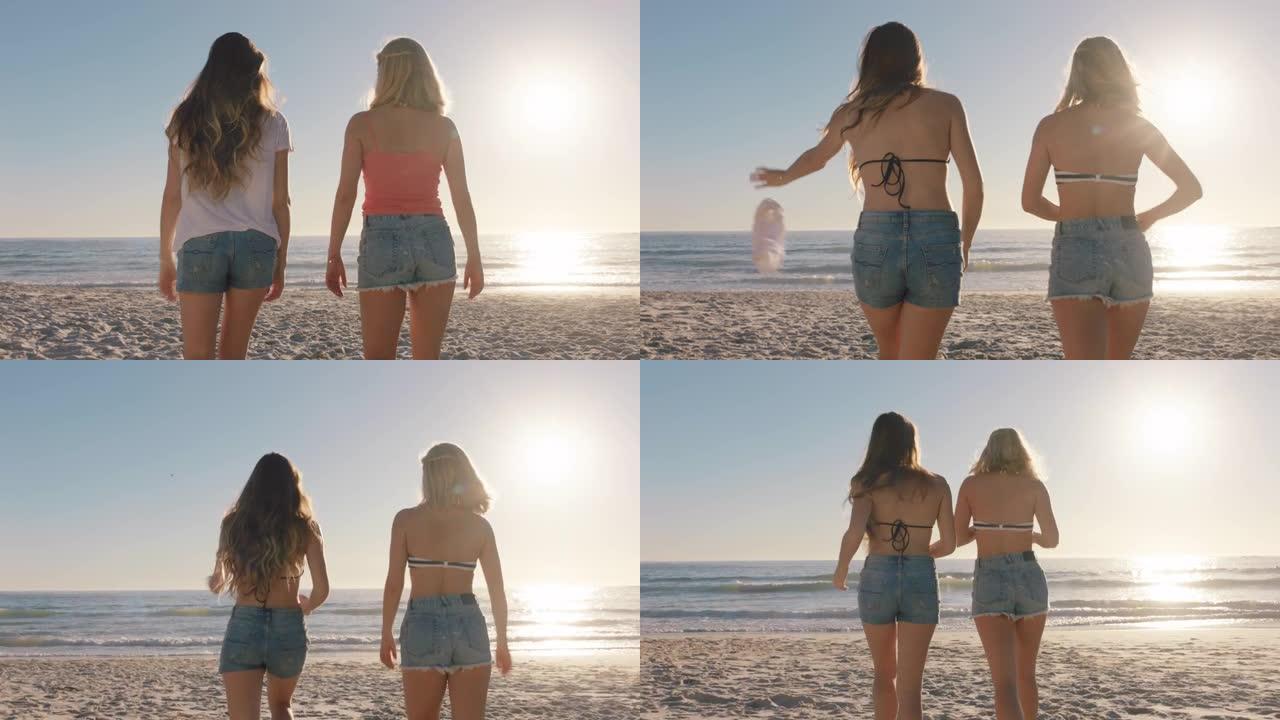 女朋友在海滩上脱衣服，穿着牛仔短裤走向大海，享受温暖的夏日度假
