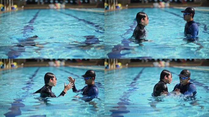 慢动作亚洲中国游泳教练在游泳便便中拥抱他的学生