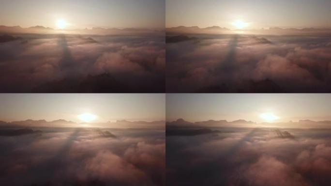 早晨云雾上方的山上的日出天空的航拍