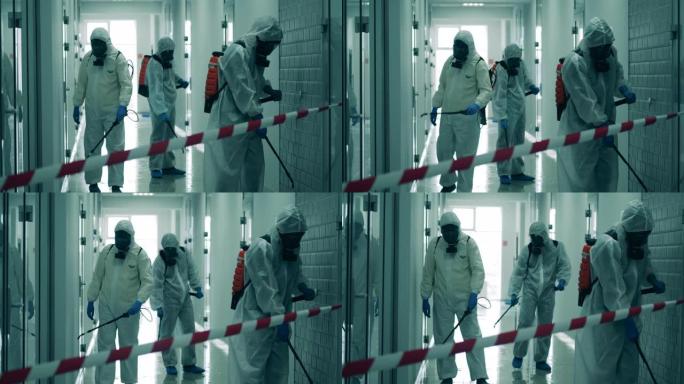 三名工人对走廊进行消毒以清除病毒。
