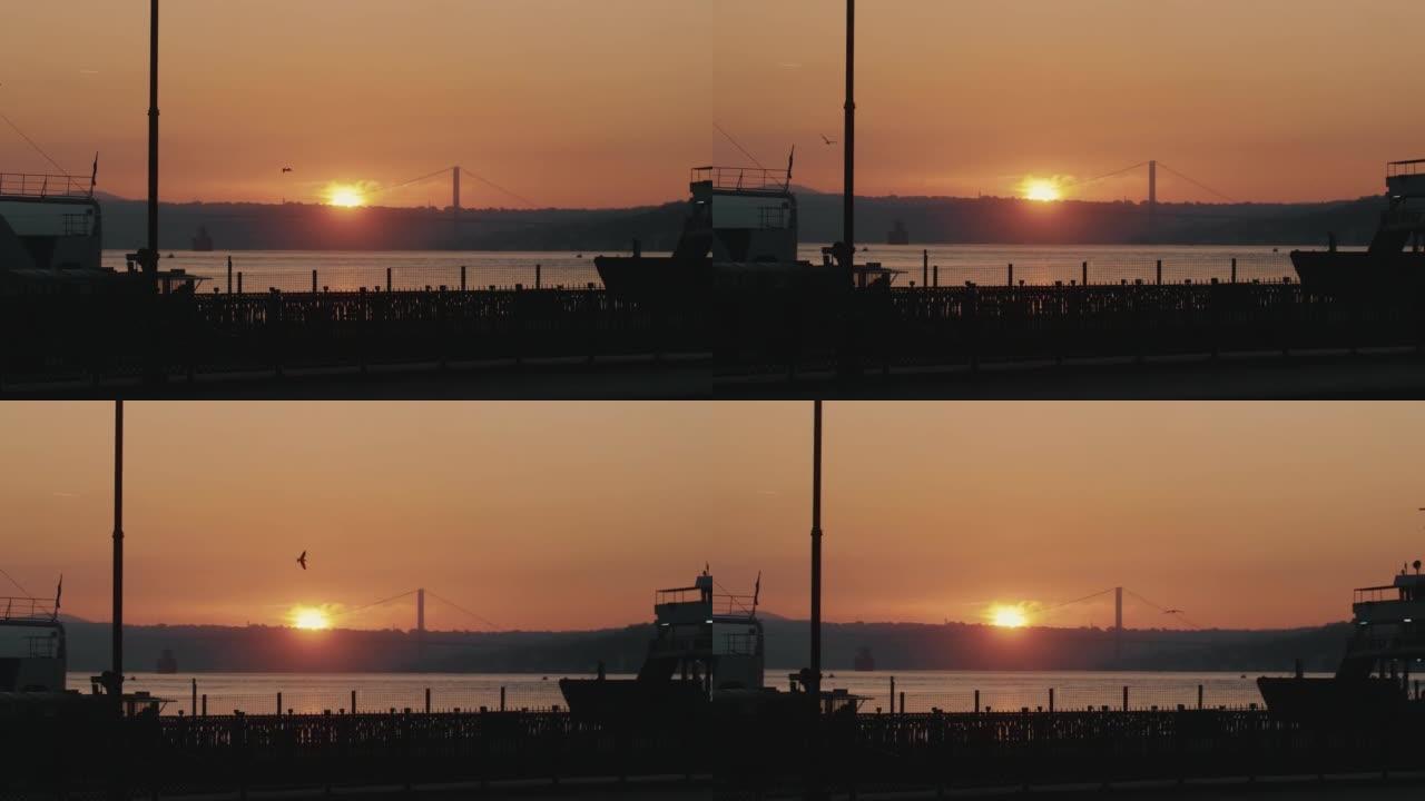 宁静的背景拍摄橙色日落在平静的海滨码头风景，壮丽的海洋日落全景。