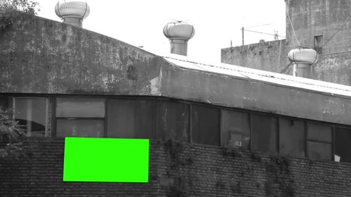 旧工厂墙上的空白广告牌或绿屏广告牌。黑白色调。