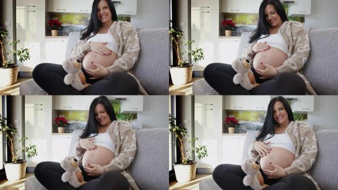SLO MO怀孕后期年轻女子的肖像抚摸着她的肚子
