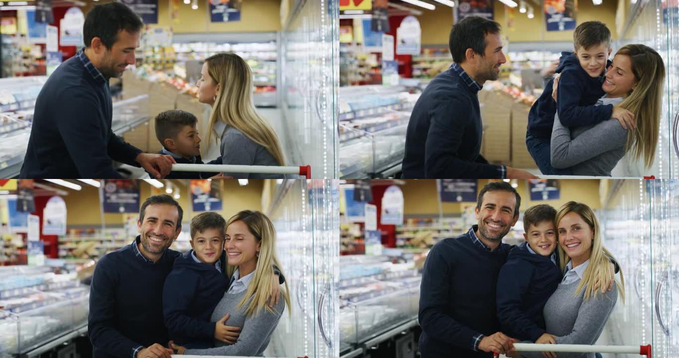 父亲，母亲和儿子的幸福家庭的真实照片在相机中微笑，同时在超市一起购物。