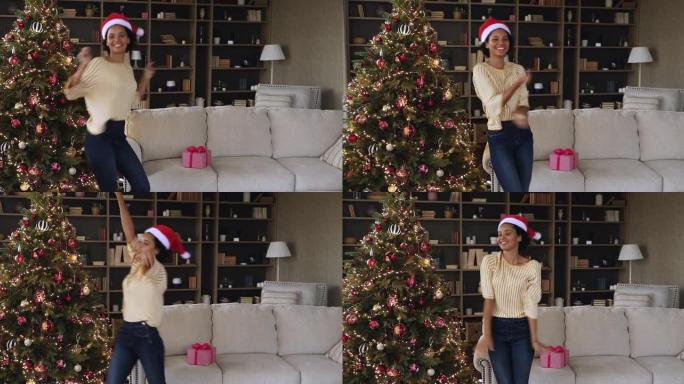 黑人千禧一代妇女在装饰好的圣诞树下在家跳舞