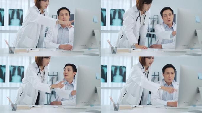 两名医生在医疗室监控计算机屏幕上进行分析和讨论