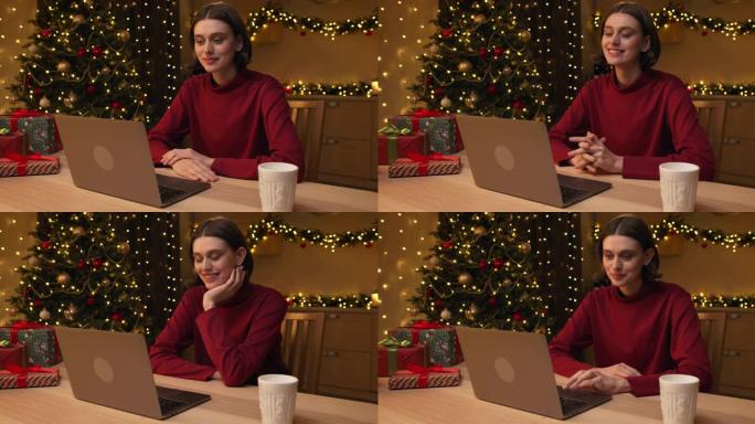 一个穿着红色毛衣的年轻迷人女人正在通过笔记本电脑上的视频通话与某人交谈，