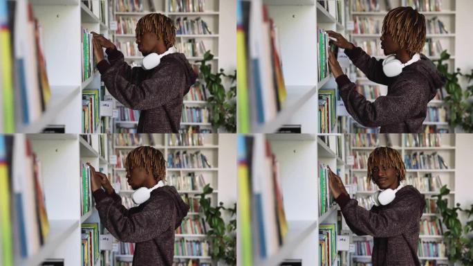 长发lock发型的非洲男人在图书馆选择一本书