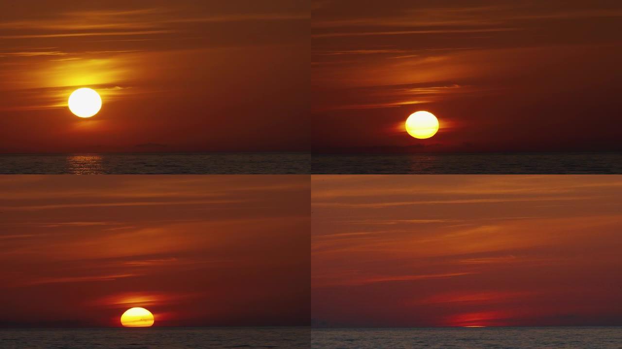 延时日落天空和美丽的海洋背景。橙色的阳光天空在反射的海洋画面上。夏日红日海景。自旋漂移云层中的大太阳