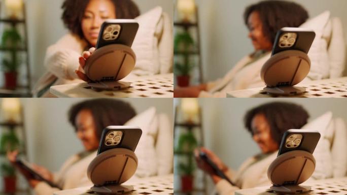 快乐的女人使用智能手机控制设备。