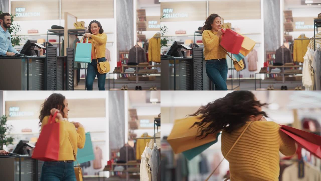 服装店: 柜台上的年轻女子从友好的零售助理那里拿起带有衣服的购物袋，心情愉快，微笑，旋转和跳舞。拥有