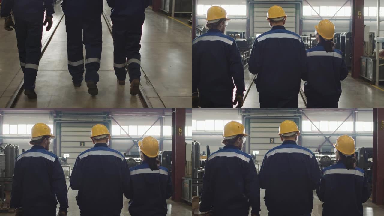 穿着工作服穿过工厂的工厂工人的后视图