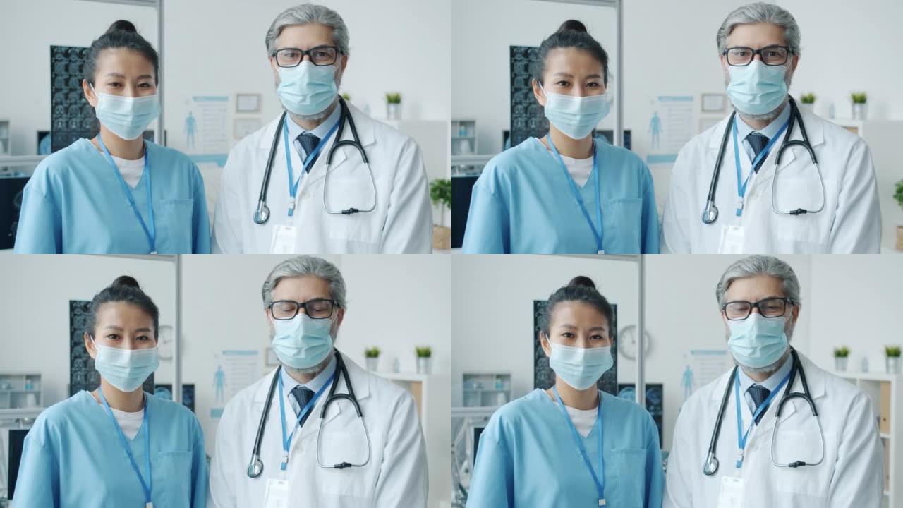 医生和护士戴着医用口罩和制服站在办公室的肖像