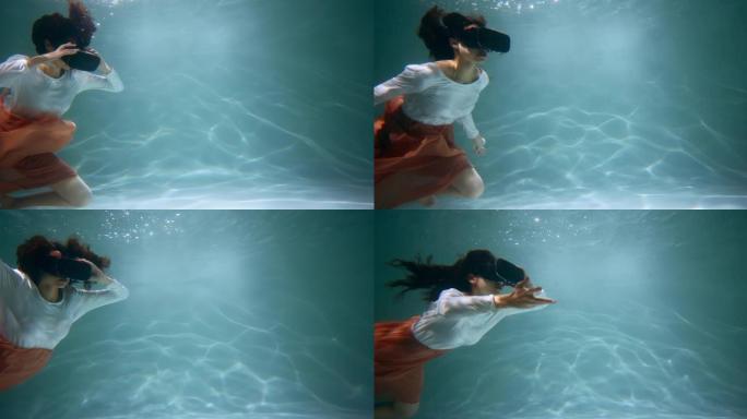 虚拟现实的概念。年轻迷人的混血女人使用VR耳机漂浮在水下慢动作深处。