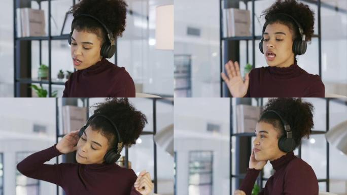 4k视频片段，一位年轻的女商人在现代办公室里用耳机听音乐