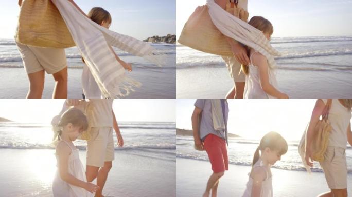 4k视频片段，一个小女孩在海滩上与父母结为纽带